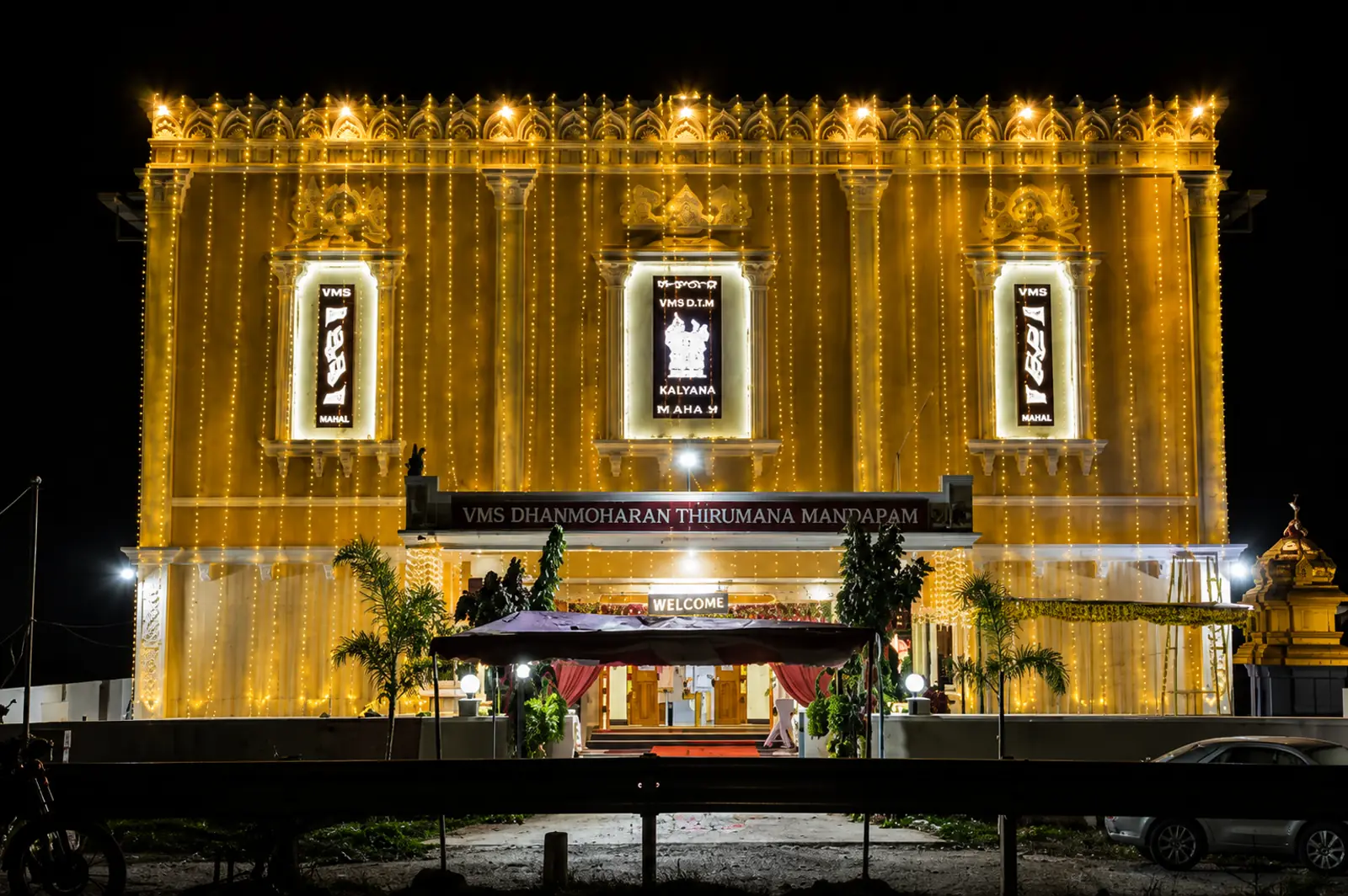 The mandapam illuminated with golden festoon lighting at night